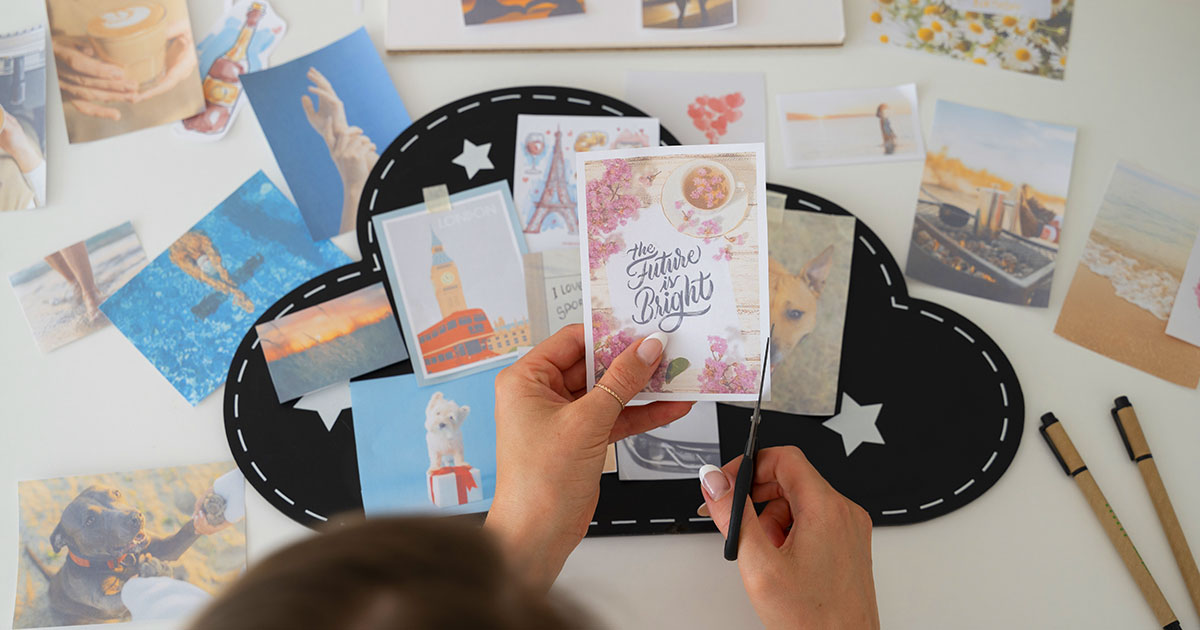 A woman's hands cutting out an image to use for scrapbooking