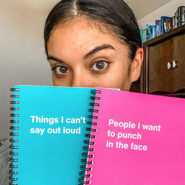 A customer holding up her WTF Notebooks