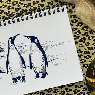 A WTF Notebook with a drawing of penguins on the inside