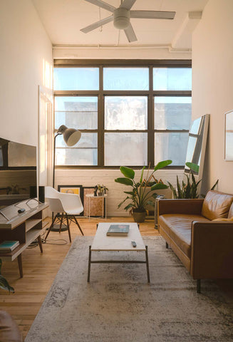 An image of a living room with a large rug on the floor