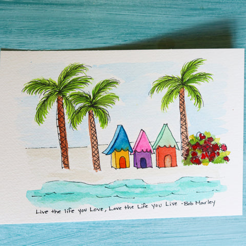 Postcard with small illustration beach houses and palm trees with Bob Marley quote, "live the life you love, love the life you live"