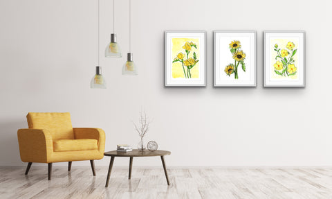 3 framed yellow floral watercolor prints in a a living room with a yellow arm chair and table