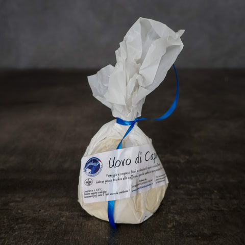 Uovo di Capra goat cheese wrapped in white paper.