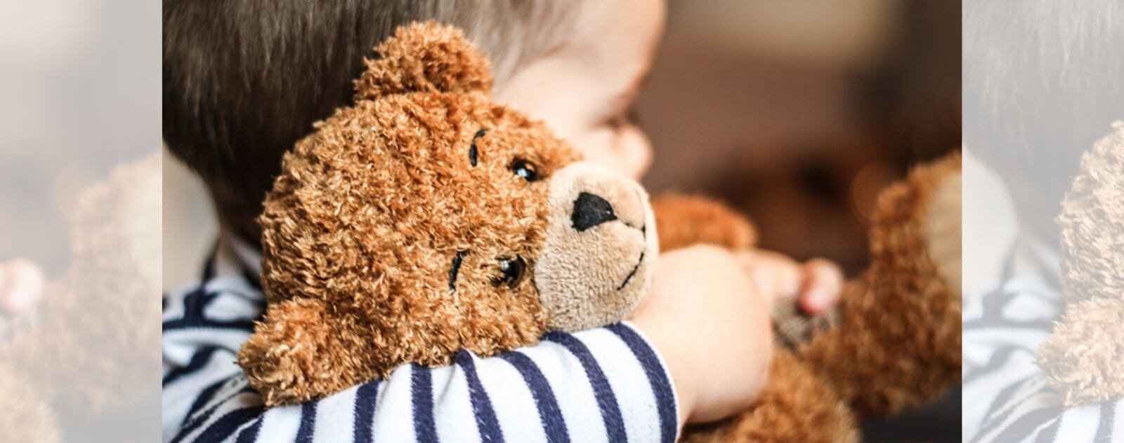 Enfant qui Câline son Ours en Peluche