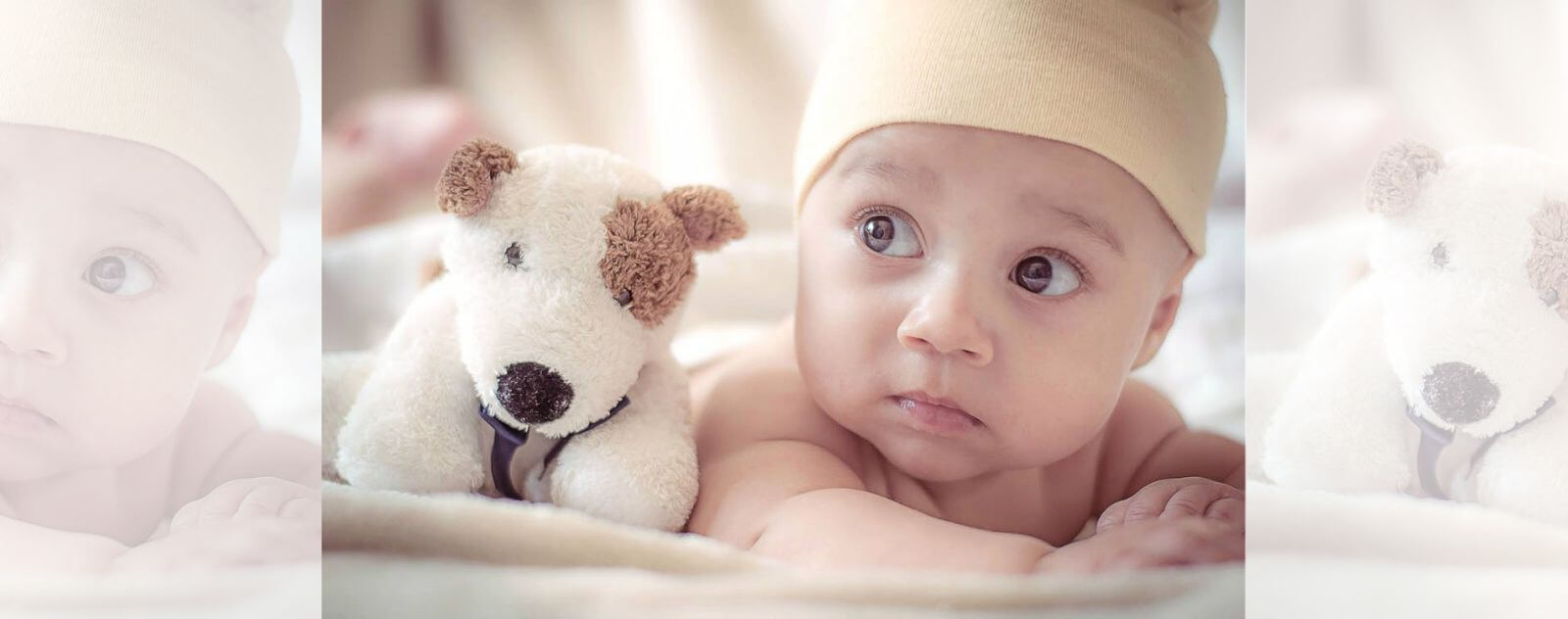 Infant with his Doudou Doudou
