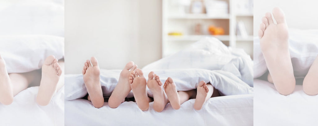 Family View of Feet in a Bed