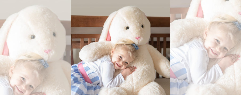 Giant teddy bear rabbit and little blonde girl cuddling