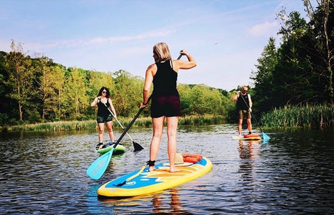 three women on paddle boards