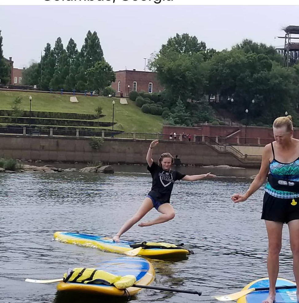 woman falling off her paddleboard
