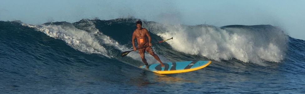 surfing a paddle board in hawaii