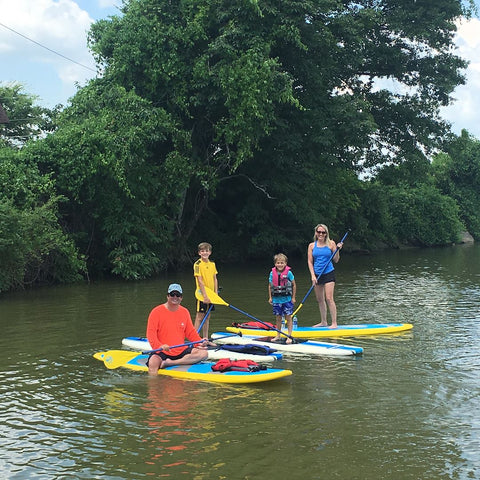 family on paddle boards