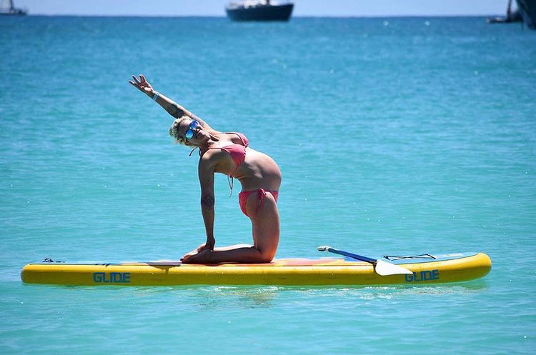pregnant woman on inflatable paddle board