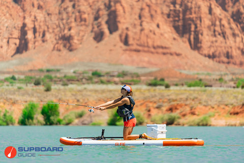 woman fishing on a paddle board