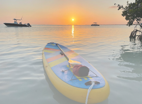 inflatable paddle board at sunset