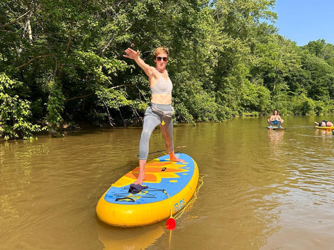 sup yoga on an inflatable paddle board