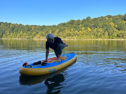 sup yoga on an inflatable paddle board