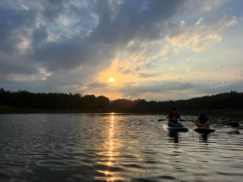 paddle boards at sunset