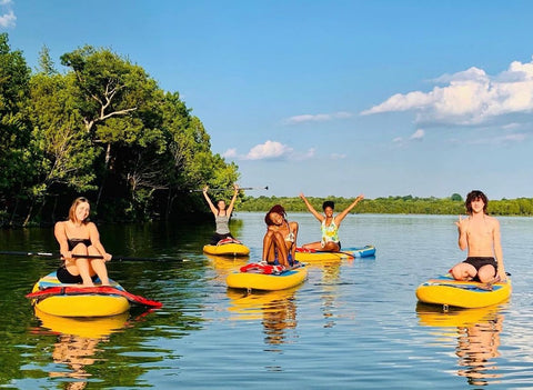 people sitting on inflatable paddle boards