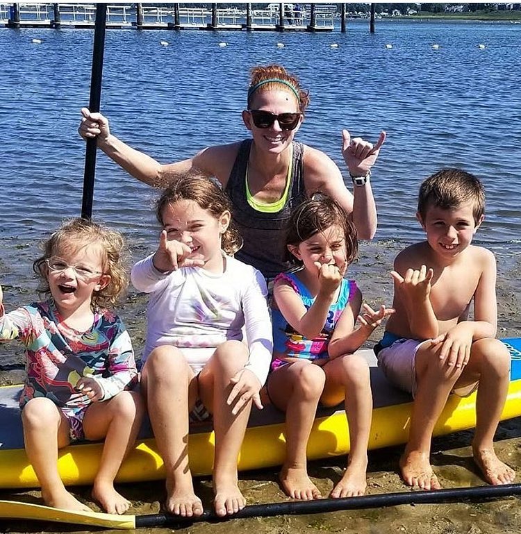 kids on an inflatable paddle board