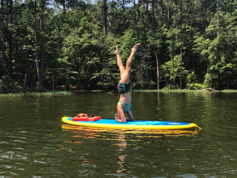 headstand on a paddle board