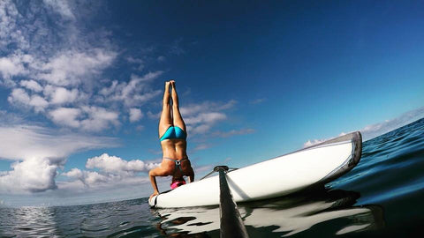 headstand on a paddleboard