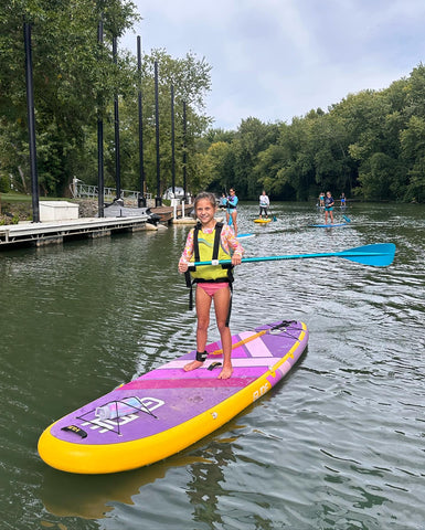 girl on inflatable paddle board