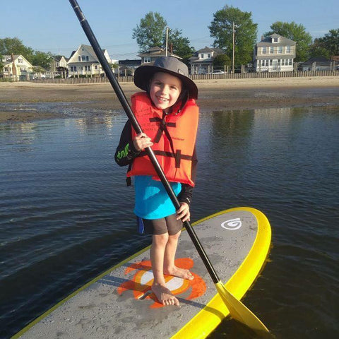 child paddling a paddle board
