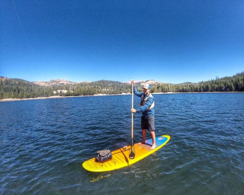 man paddling a paddle board