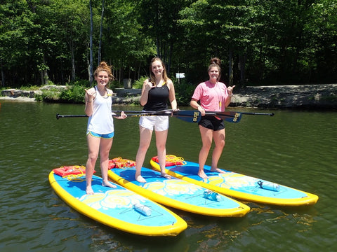 women on paddle boards