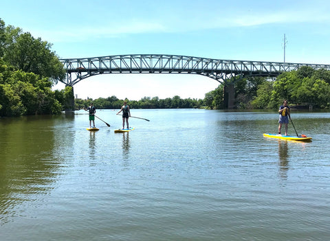 paddle boards on a river