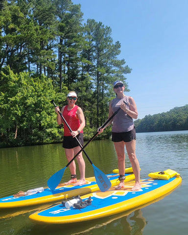 2 women on paddle boards