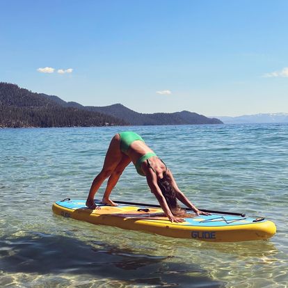 yoga on an inflatable paddle board