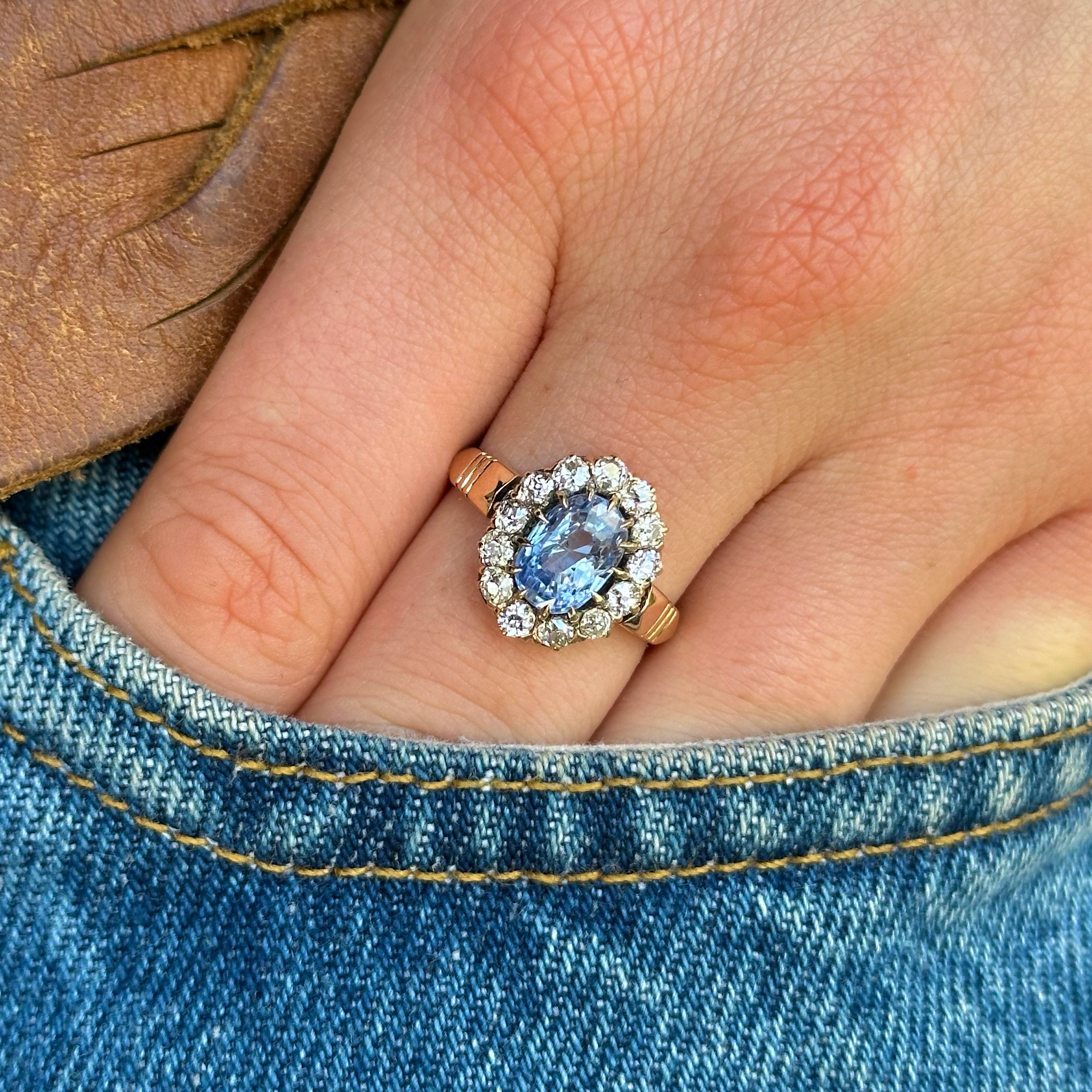 Antique sapphire and diamond ring, worn on hand in pocket of jeans.