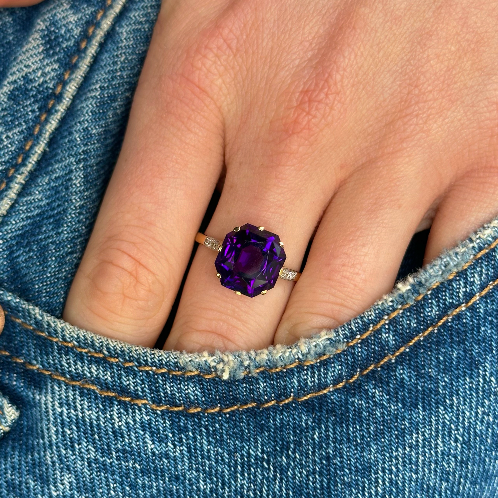 Antique, amethyst and diamond single-stone ring, worn on hand.