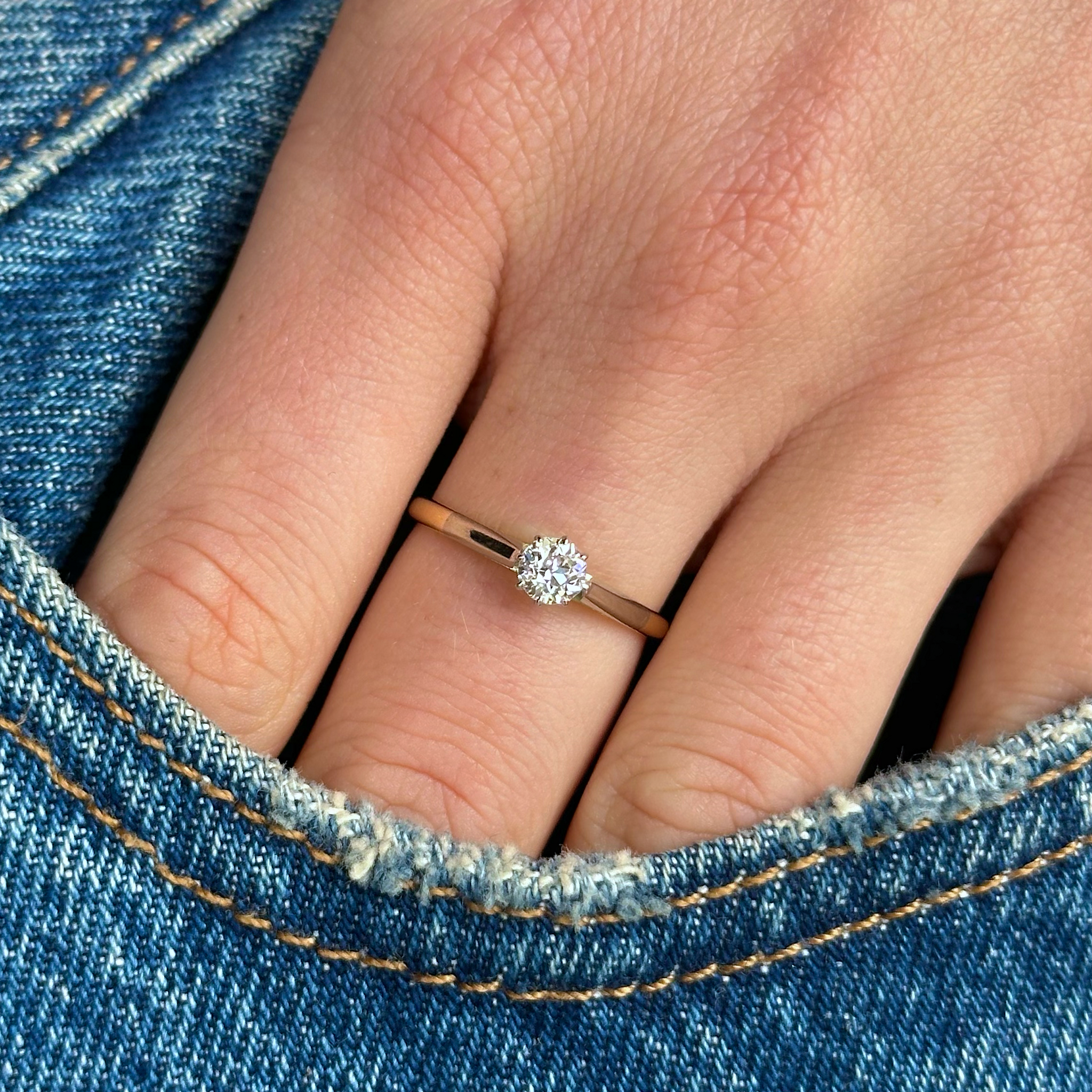 Antique, Edwardian Solitaire Diamond Engagement Ring, 18ct Yellow Gold and Platinum worn on hand in pocket of jeans