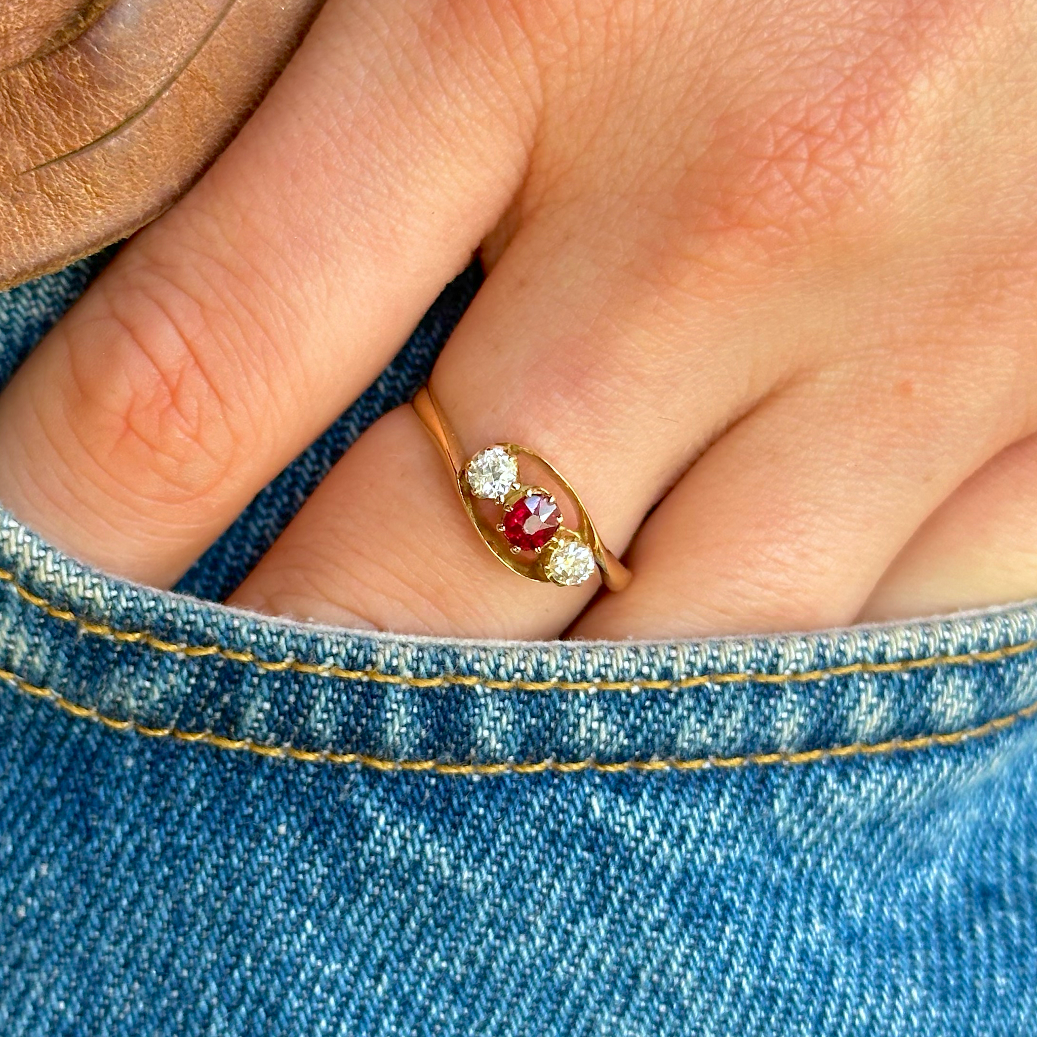 Antique, Three-Stone Ruby and Diamond Engagement Ring, 18ct Yellow Gold worn on hand in pocket of jeans