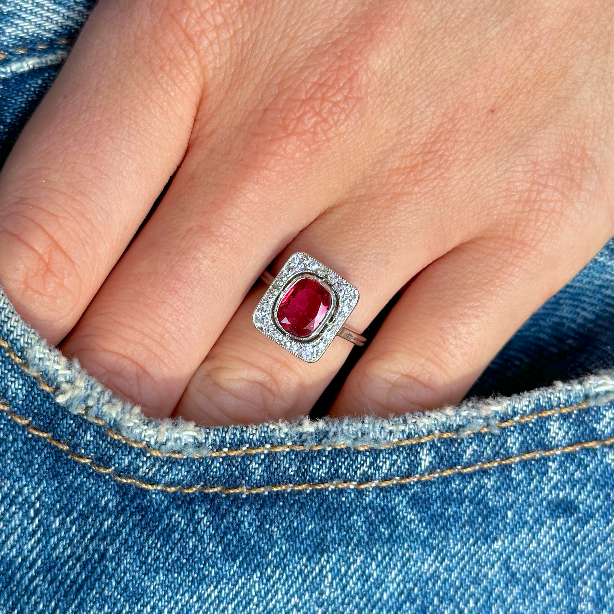 ruby and diamond ring on hand in pocket of jeans