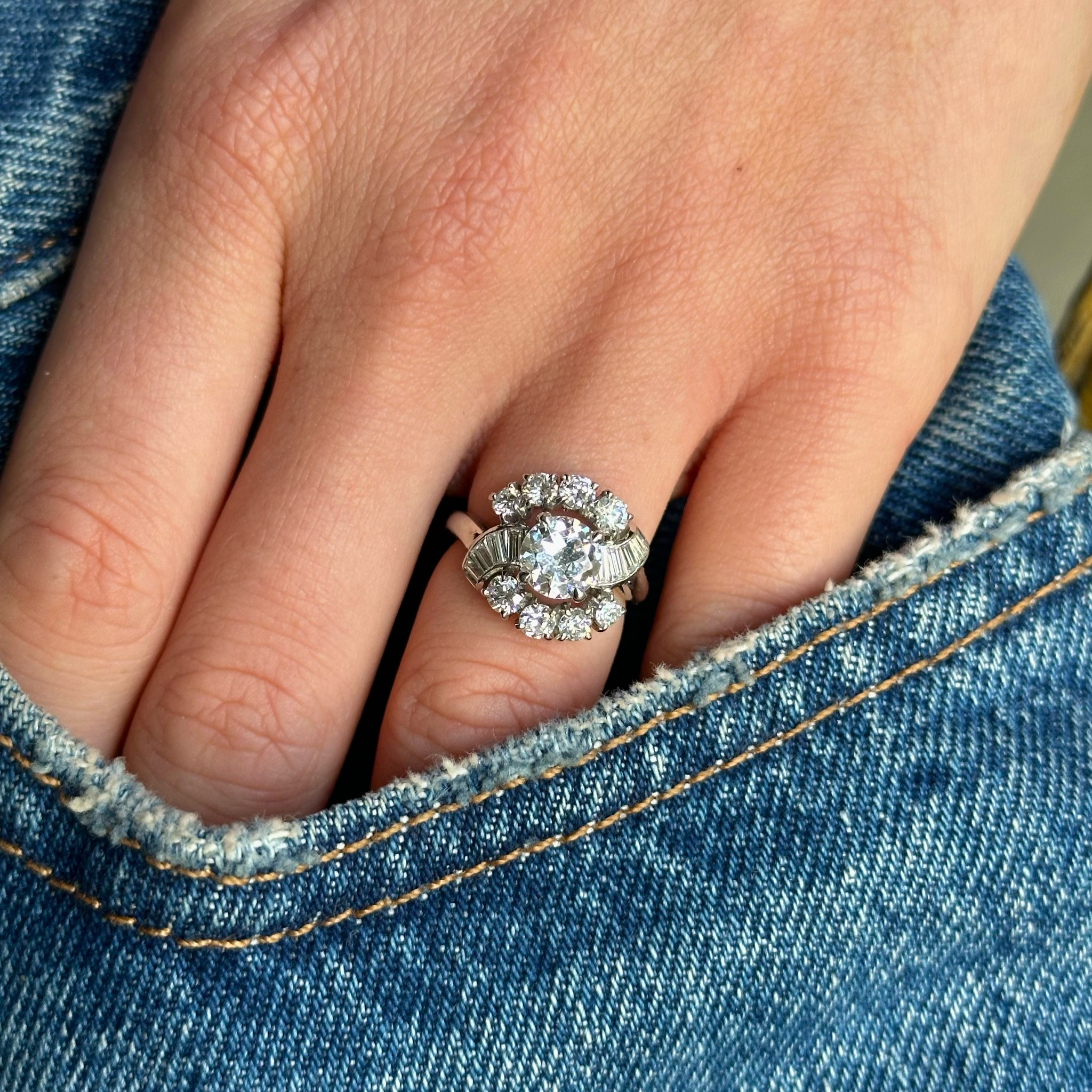 Cartier diamond engagement ring worn on hand in pocket of jeans