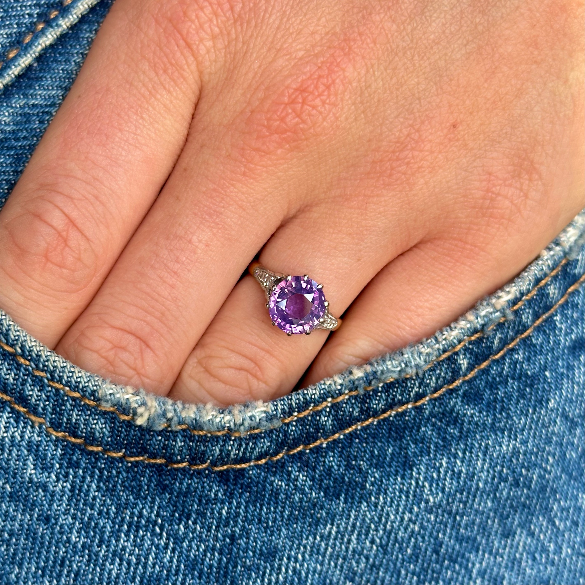 edwadian amethyst ring worn on hand in pocket of jeans