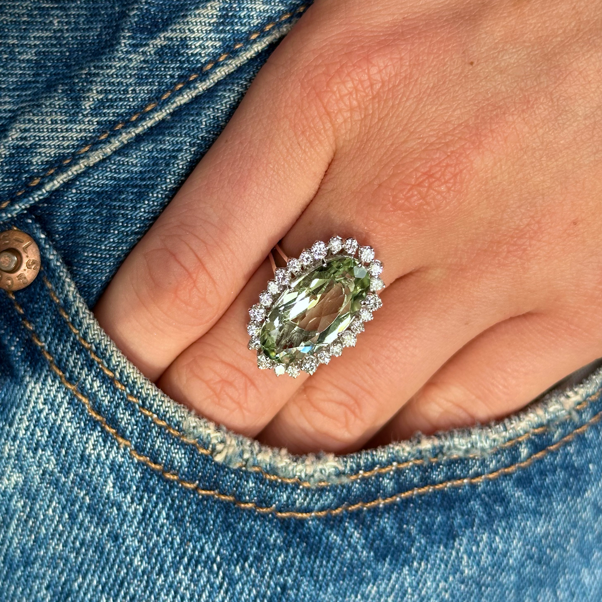 Mint quartz and diamond cluster cocktail ring worn on hand in pocket of jeans