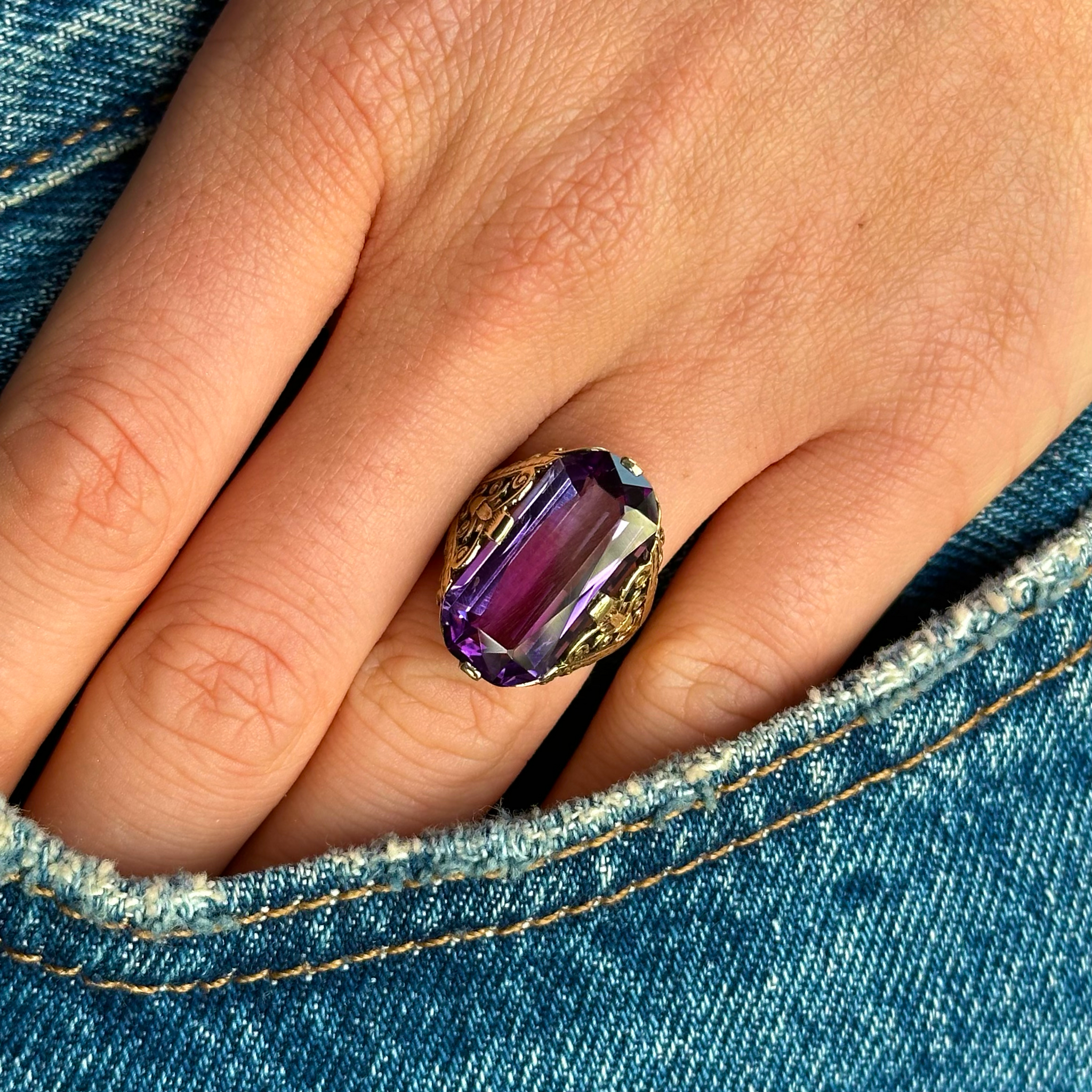 victorian amethyst and 14ct yellow gold ring worn on hand in pocket of jeans