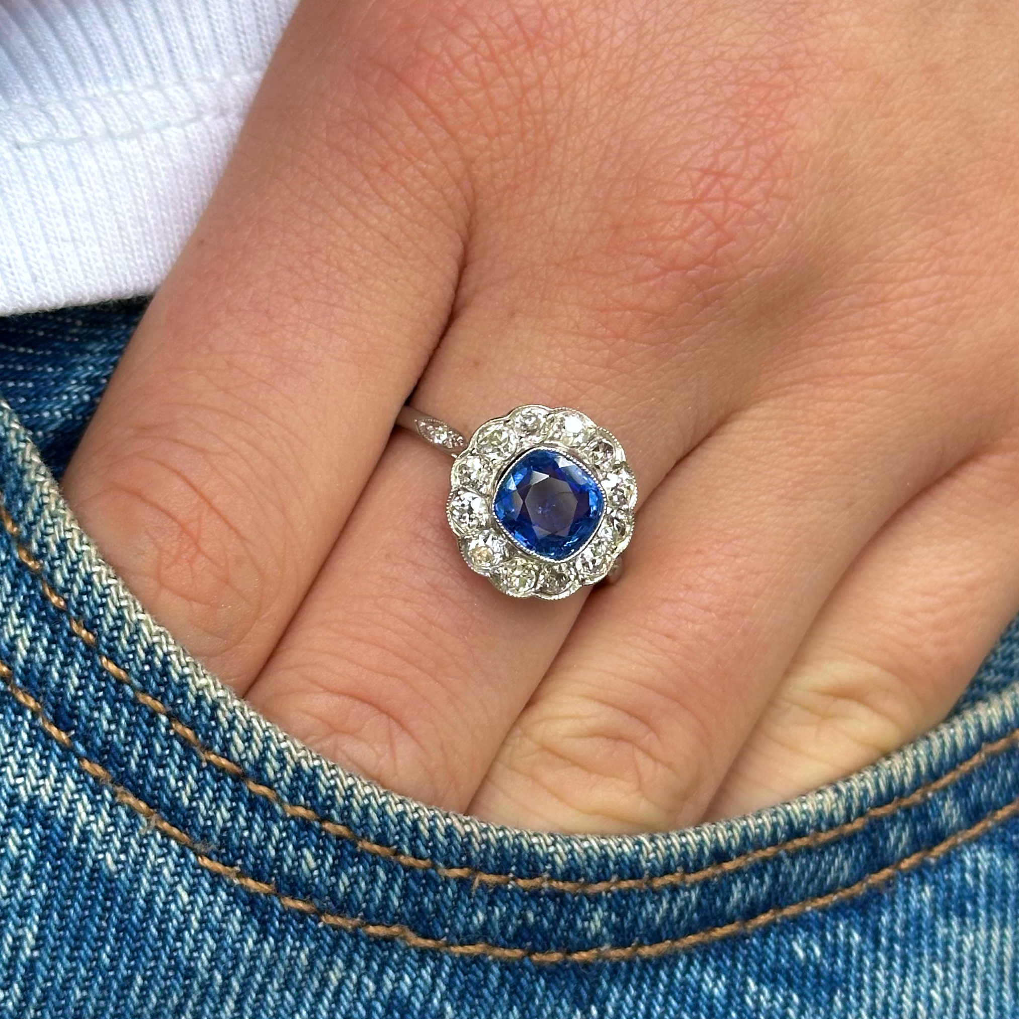 Vintage, 1940s Ceylon Cushion-Cut Sapphire and Diamond Cluster Engagement Ring, worn on hand in pocket of jeans