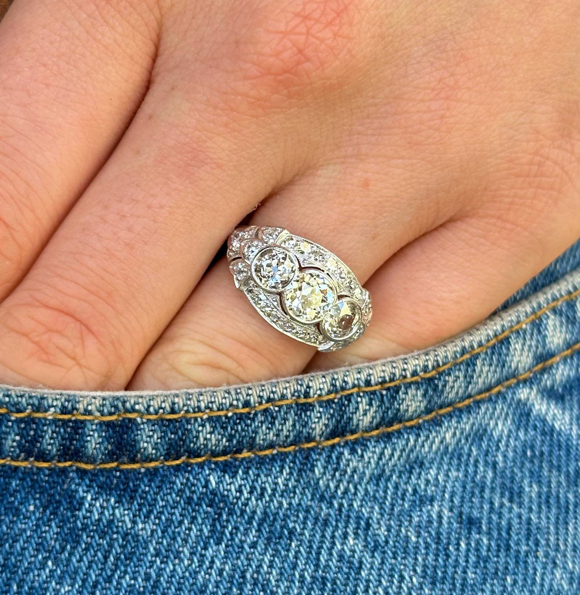 Vintage, Art Deco Diamond Three-Stone Engagement Ring, worn on hand in pocket of jeans.