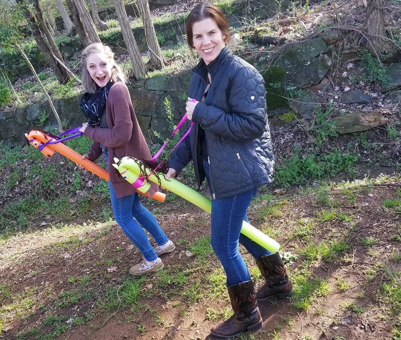 Girls having fun with stick horses