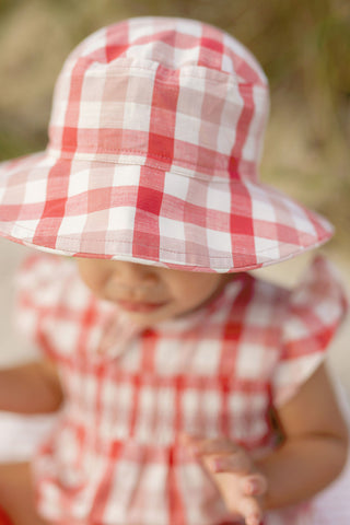 Child in bucket hat and matching dress