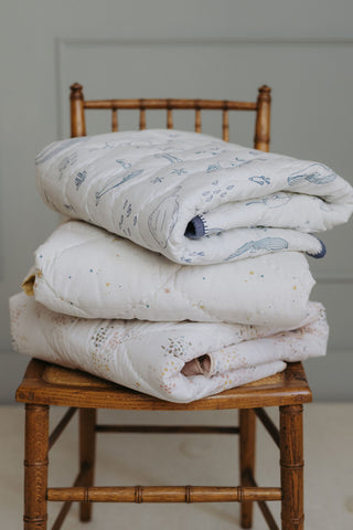 chambray blankets folded on chair