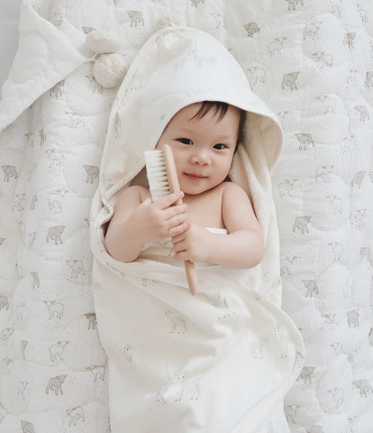 baby wearing hooded towel