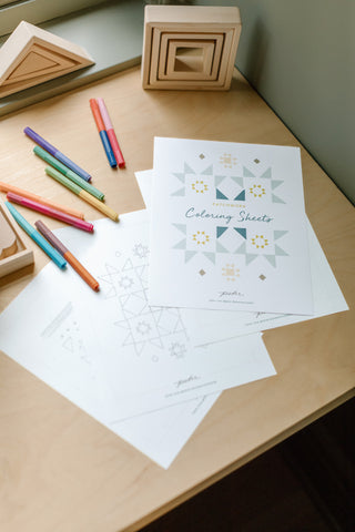 An image of Pehr’s printable coloring sheets on a desk with some pencils.