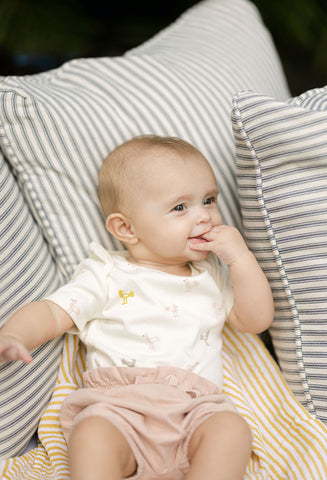 baby in organic clothing with swaddle 