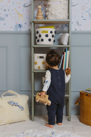 Child with toys and shelf